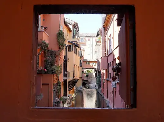 finestrella di via piell image of the little village(little Venice) that is a canal with a small orange window to see it through